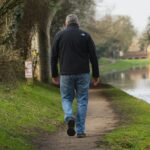 Illustrative lifestyle photograph of a man walking outdoors; photo by Caspar Rae on Unsplash